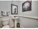 Small but functional bathroom with pedestal sink and seashell art at 1006 Clubhouse Dr., North Myrtle Beach, SC 29582