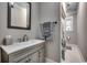 Well-lit bathroom with a neutral color palette, single vanity, and shower at 1006 Clubhouse Dr., North Myrtle Beach, SC 29582