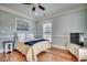 Cozy bedroom with blue and tan accents, hard wood floors, and large window at 1006 Clubhouse Dr., North Myrtle Beach, SC 29582