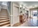 Welcoming entryway with staircase, tiled floors, and coastal decor at 1006 Clubhouse Dr., North Myrtle Beach, SC 29582