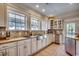 Bright kitchen showcases white cabinetry, stainless steel appliances, and granite countertops at 1006 Clubhouse Dr., North Myrtle Beach, SC 29582