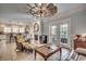 Living area with a fireplace, a windmill ceiling fan, and view into the kitchen at 1006 Clubhouse Dr., North Myrtle Beach, SC 29582