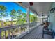 Outdoor porch features seating, a table, and a view of mature trees at 1006 Clubhouse Dr., North Myrtle Beach, SC 29582