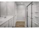 Modern bathroom featuring double sinks, white cabinetry, and a glass-enclosed shower with tile surround at 1079 Oak Meadow Dr., Conway, SC 29526