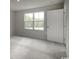 Bedroom with neutral carpet, a large window with a view of trees, and a white interior door at 1079 Oak Meadow Dr., Conway, SC 29526