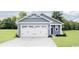 Charming single-story home featuring a two-car garage, blue siding, and well-maintained landscaping at 1079 Oak Meadow Dr., Conway, SC 29526