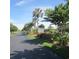 Inviting neighborhood entrance with lush landscaping and a Marsh Creek Dock street sign at 135 S Dunes Dr., Pawleys Island, SC 29585