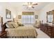 Main bedroom featuring carpet, queen bed, end tables, dresser and ceiling fan at 1517 Palmina Loop # B, Myrtle Beach, SC 29588