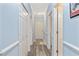 Bright hallway with grey flooring and light blue walls leads to various rooms, including a bathroom at 1537 Lanterns Rest Rd. # 202, Myrtle Beach, SC 29579