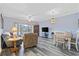 The living room features grey hardwood flooring with a large sliding glass door that leads to the balcony at 1537 Lanterns Rest Rd. # 202, Myrtle Beach, SC 29579