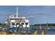 Casino boat docked with American flags on display, set against a backdrop of a river and partly cloudy sky at 1609 Seachase Way, North Myrtle Beach, SC 29582