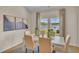 Inviting dining area with lake views featuring a white table with seating for six and modern decor at 1609 Seachase Way, North Myrtle Beach, SC 29582