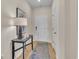 Hallway with wood flooring and a dark wood console table with lamp and decor at 1609 Seachase Way, North Myrtle Beach, SC 29582