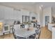 Bright kitchen with white cabinets, stainless steel appliances, breakfast table, and seamless access to laundry room at 1609 Seachase Way, North Myrtle Beach, SC 29582