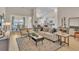 Bright living room featuring stylish furniture, modern decor, and an open layout, flowing into the dining area at 1609 Seachase Way, North Myrtle Beach, SC 29582