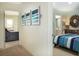 Hallway view leading to a bedroom with a striking sunburst mirror, plus living area and bathroom views at 1613 Seachase Way, North Myrtle Beach, SC 29582