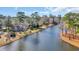 Aerial view of a brick home with a beautiful waterfront and lush greenery at 1616 Hawthorn Dr., Pawleys Island, SC 29585