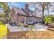 Brick home backyard with outdoor seating, patio, well-maintained lawn, and mature trees at 1616 Hawthorn Dr., Pawleys Island, SC 29585