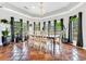 Well-lit dining room featuring tile floors, stylish chandelier, and a full view of the serene backyard at 1616 Hawthorn Dr., Pawleys Island, SC 29585