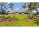 Inviting exterior showcasing landscaped grounds, manicured lawn, and classic brick architecture at 1616 Hawthorn Dr., Pawleys Island, SC 29585