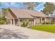 Elegant brick home boasting a side-entry garage, lush landscaping, and a well-maintained front yard at 1616 Hawthorn Dr., Pawleys Island, SC 29585