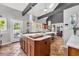Kitchen featuring a double sink, island seating and an entrance to the patio at 1616 Hawthorn Dr., Pawleys Island, SC 29585