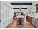 Bright kitchen featuring a large island, stainless steel appliances, and terra cotta floors at 1616 Hawthorn Dr., Pawleys Island, SC 29585
