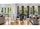 Bright living space showcasing hardwood floors, neutral paint, backyard views, and an upright piano at 1616 Hawthorn Dr., Pawleys Island, SC 29585