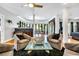 Bright living room featuring hardwood floors, cozy seating, and an open floor plan to the dining area at 1616 Hawthorn Dr., Pawleys Island, SC 29585