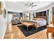 Spacious main bedroom with a fireplace, hardwood floors, ceiling fan, and an ensuite bathroom at 1616 Hawthorn Dr., Pawleys Island, SC 29585