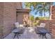 Cozy brick-walled patio with comfortable seating, wrought iron accents, and a serene garden view at 1616 Hawthorn Dr., Pawleys Island, SC 29585
