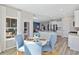 Bright breakfast nook with seating, opening to a kitchen featuring stainless steel appliances and granite countertops at 1705 Seachase Way, North Myrtle Beach, SC 29582