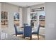 Cozy breakfast nook features a round table, blue chairs, and natural light from surrounding windows at 1705 Seachase Way, North Myrtle Beach, SC 29582