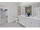 Elegant bathroom with dual sinks, decorative flowers, and a linen closet in view at 1713 Seachase Way, North Myrtle Beach, SC 29582