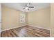 Bedroom with neutral walls, wood-look floors, and a ceiling fan for optimal temperature at 177 Reef Run Rd., Pawleys Island, SC 29585