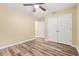 Bedroom with wood-look floors, ceiling fan and closet for lots of space and storage at 177 Reef Run Rd., Pawleys Island, SC 29585