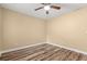 A well-lit bedroom features wood-look floors and a ceiling fan for temperature control at 177 Reef Run Rd., Pawleys Island, SC 29585