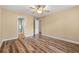 Spacious main bedroom featuring hardwood floors, neutral paint, and an open door to the main bathroom at 177 Reef Run Rd., Pawleys Island, SC 29585