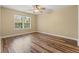 Bright bedroom featuring hardwood floors, a ceiling fan, and a sunlit window view at 177 Reef Run Rd., Pawleys Island, SC 29585