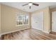 Bright bedroom with hardwood floors, a ceiling fan, large window and closet at 177 Reef Run Rd., Pawleys Island, SC 29585