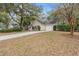 Charming single-story home with a well-manicured lawn, driveway, and attached garage at 177 Reef Run Rd., Pawleys Island, SC 29585