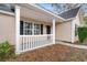 Charming front porch with white railings and black shutters accentuating the windows at 177 Reef Run Rd., Pawleys Island, SC 29585