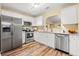 Modern kitchen featuring stainless steel appliances, granite countertops, white cabinets, and modern lighting at 177 Reef Run Rd., Pawleys Island, SC 29585