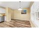 Eat-in kitchen featuring stainless steel appliances, granite countertops, white cabinets, and modern lighting at 177 Reef Run Rd., Pawleys Island, SC 29585