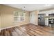 Eat-in kitchen featuring stainless steel appliances, granite countertops, white cabinets, and modern lighting at 177 Reef Run Rd., Pawleys Island, SC 29585