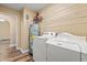 Laundry room with a washer, dryer, water heater, and overhead wire shelving at 177 Reef Run Rd., Pawleys Island, SC 29585