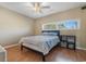 This well-lit bedroom has a ceiling fan, wood flooring, and double windows at 1851 Fairway Ridge # 7C, Surfside Beach, SC 29575