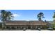 Wide exterior view of townhomes showing the architecture, including upper-level windows and covered patios at 1851 Fairway Ridge # 7C, Surfside Beach, SC 29575