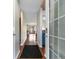 Bright hallway with wood floors leading to the kitchen with blue cabinets at 1851 Fairway Ridge # 7C, Surfside Beach, SC 29575