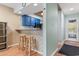 Cozy kitchen area with blue cabinets and adjacent hallway at 1851 Fairway Ridge # 7C, Surfside Beach, SC 29575